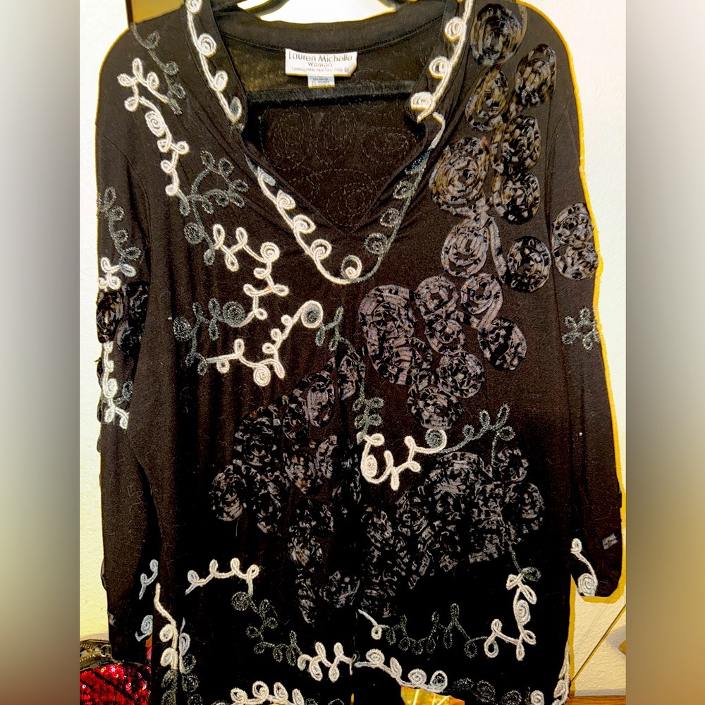 Black top with embroidered design